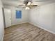 Neutral bedroom with hardwood floors, ceiling fan and window at 1487 Arnold Dr, Lawrenceville, GA 30043