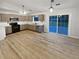 Modern kitchen with stainless steel appliances, white backsplash, and sliding glass doors leading to the backyard at 1487 Arnold Dr, Lawrenceville, GA 30043