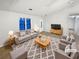 Staged living room with a plush gray sofa, patterned rug, and modern decor, creating a welcoming and stylish atmosphere at 1487 Arnold Dr, Lawrenceville, GA 30043