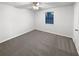 Cozy main bedroom featuring plush carpeting, a ceiling fan, and a large window offering natural light at 1487 Arnold Dr, Lawrenceville, GA 30043