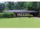 Charming brick home featuring a covered carport, manicured lawn, and mature trees at 2314 Bryant Dr, Atlanta, GA 30344