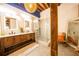 Rustic bathroom features a double vanity, illuminated mirrors, and a glass-enclosed shower with industrial accents at 342 Marietta Nw St # 8, Atlanta, GA 30313