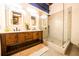 Bright bathroom with wood vanity, double sinks, illuminated mirrors, and glass shower offers industrial-style living at 342 Marietta Nw St # 8, Atlanta, GA 30313