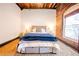 Comfortable bedroom with exposed brick, rustic wood floors, and soft, warm lighting at 342 Marietta Nw St # 8, Atlanta, GA 30313