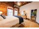 Cozy bedroom with exposed brick, rustic wood floors, and adjacent access to common areas at 342 Marietta Nw St # 8, Atlanta, GA 30313