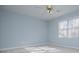 Bright bedroom with neutral carpet, blue walls, ceiling fan, and natural light from the window at 3595 Mason Ridge Dr, Winston, GA 30187