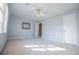 Bright bedroom with neutral carpet, blue walls, ceiling fan, and natural light from the window at 3595 Mason Ridge Dr, Winston, GA 30187