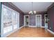 Dining room with hardwood floors, large windows, and a decorative chandelier at 3595 Mason Ridge Dr, Winston, GA 30187