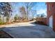 Wide driveway curving toward a brick home, complemented by mature trees and landscaping at 3595 Mason Ridge Dr, Winston, GA 30187