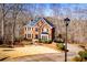 Beautiful brick home nestled among trees, with a circular driveway and professionally landscaped front yard at 3595 Mason Ridge Dr, Winston, GA 30187