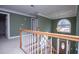 Hallway with chandelier, green walls, and white railings at 3595 Mason Ridge Dr, Winston, GA 30187