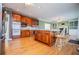 A well-lit kitchen featuring stainless steel appliances, an island, and hardwood floors at 3595 Mason Ridge Dr, Winston, GA 30187