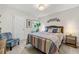 Cozy bedroom featuring natural light, a bed, a chair, an area rug, and simple decor at 613 Everett Ln, Woodstock, GA 30188