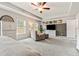 Spacious bedroom with a ceiling fan, lounge chair, large windows, and neutral wall paint and carpet at 613 Everett Ln, Woodstock, GA 30188