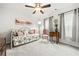 Comfortable bedroom featuring modern lighting, a daybed, large windows, and neutral wall paint and carpet at 613 Everett Ln, Woodstock, GA 30188