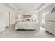 Bright bedroom featuring neutral colors, tray ceiling, carpet, and large windows that offer natural light at 613 Everett Ln, Woodstock, GA 30188