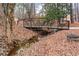 Nature path with wooden bridge in a serene community at 613 Everett Ln, Woodstock, GA 30188