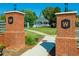 A brick entrance with signage leads to a community gazebo and green space at 613 Everett Ln, Woodstock, GA 30188