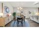 Dining area featuring a stylish table set, modern decor, and ample natural light at 613 Everett Ln, Woodstock, GA 30188