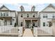 Charming two-story home featuring gray siding, white trim, and a welcoming front porch and fence at 613 Everett Ln, Woodstock, GA 30188