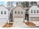 Modern townhome with two-car garage and manicured landscaping at 613 Everett Ln, Woodstock, GA 30188