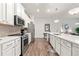 This modern kitchen is equipped with stainless steel appliances, ample counter space and sleek cabinetry at 613 Everett Ln, Woodstock, GA 30188