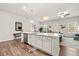 This open kitchen features a large center island with seating, stainless steel appliances and wood flooring at 613 Everett Ln, Woodstock, GA 30188