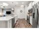 This open kitchen features stainless steel appliances, and a large center island with seating at 613 Everett Ln, Woodstock, GA 30188