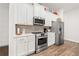 Modern kitchen featuring stainless steel appliances and ample counter space at 613 Everett Ln, Woodstock, GA 30188