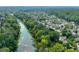 Aerial view of community along scenic river, surrounded by mature trees and well-kept homes at 9135 Etching Overlook, Johns Creek, GA 30097