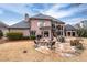 Large backyard with stone patio, outdoor fire pit, and manicured lawn at 9135 Etching Overlook, Johns Creek, GA 30097