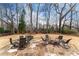 Inviting backyard with a stone patio, fire pit, and comfortable seating, ideal for relaxing or entertaining guests at 9135 Etching Overlook, Johns Creek, GA 30097