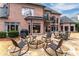 Expansive backyard featuring stone patio, fire pit, and outdoor seating area at 9135 Etching Overlook, Johns Creek, GA 30097