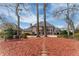 Expansive backyard featuring mature trees and a cozy swing set, perfect for relaxation and outdoor activities at 9135 Etching Overlook, Johns Creek, GA 30097