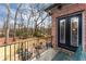 Charming balcony with wrought iron railing overlooking the landscaped backyard and mature trees at 9135 Etching Overlook, Johns Creek, GA 30097