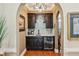 Stylish wet bar area with custom cabinets, wine storage, and granite countertops at 9135 Etching Overlook, Johns Creek, GA 30097