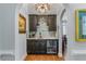 Elegant wet bar with custom cabinets, a beverage fridge, and a granite countertop at 9135 Etching Overlook, Johns Creek, GA 30097