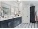 Bathroom with a double vanity, decorative mirrors, and star-patterned tile flooring at 9135 Etching Overlook, Johns Creek, GA 30097