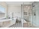 Bathroom featuring a freestanding tub, glass-enclosed shower, and decorative tile at 9135 Etching Overlook, Johns Creek, GA 30097