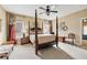 Spacious bedroom with a four-poster bed, ceiling fan, and neutral decor at 9135 Etching Overlook, Johns Creek, GA 30097