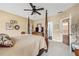 Bedroom featuring a four poster bed, neutral color palette, and view into ensuite bathroom at 9135 Etching Overlook, Johns Creek, GA 30097