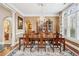 Formal dining room featuring hardwood floors, a chandelier, and ample natural light at 9135 Etching Overlook, Johns Creek, GA 30097