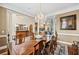 Formal dining room featuring hardwood floors, a chandelier, and ample natural light at 9135 Etching Overlook, Johns Creek, GA 30097