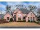 Charming brick home featuring well-maintained landscaping and a classic architectural style at 9135 Etching Overlook, Johns Creek, GA 30097