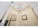 Bright foyer featuring a decorative chandelier and elegant wall art at 9135 Etching Overlook, Johns Creek, GA 30097