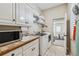 Practical laundry room with washer, dryer, sink, and ample storage shelving at 9135 Etching Overlook, Johns Creek, GA 30097