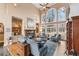 Bright living room with tall windows, fireplace, and comfortable seating area at 9135 Etching Overlook, Johns Creek, GA 30097