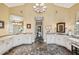 Expansive main bath includes dual vanities, expansive counter space and intricate tile flooring at 9135 Etching Overlook, Johns Creek, GA 30097