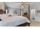 Comfortable bedroom featuring a king-size bed, soft lighting, and a ceiling fan at 9135 Etching Overlook, Johns Creek, GA 30097