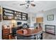 Home office featuring custom built-in shelving, a large desk, and stylish decor for a productive workspace at 9135 Etching Overlook, Johns Creek, GA 30097